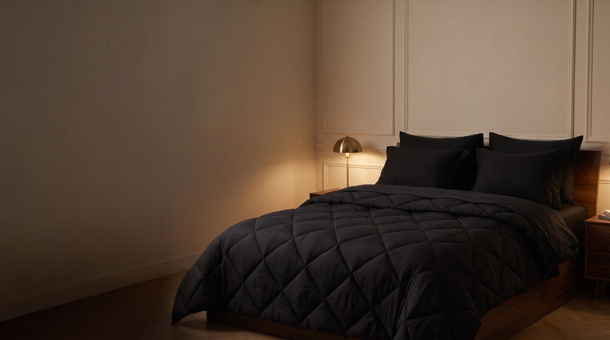 Made queen bed in Midnight, dim bedroom, warm lamp